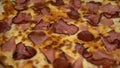 Pizza carnivor made of bacon, sausage and ham. Fast-food photography detail view of a pizza in a delivery box. Home delivered food