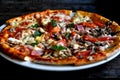 Pizza with cheese, bacon, tomato and herbs in a white bowl on a background of old boards. Royalty Free Stock Photo