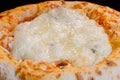 Homemade cheese pizza baking in electric oven - macro, close up Royalty Free Stock Photo