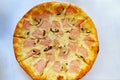 pizza with cheese, sausage and mushrooms. traditional Italian pastries. Royalty Free Stock Photo