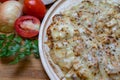 Pizza and cheese on wooden plate on table Royalty Free Stock Photo