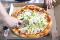 Pizza chef cutting fresh pizza