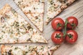 Pizza, cherry tomatoes on a light wooden background