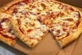 Pizza with chicken ham and tomatoes. View from above. Pizza Margaritta in a cardboard box