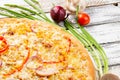 Pizza with chicken, paprika and corn. Italian kitchen and cooking concept. Chief with a pizza cutter cutting pizza to Royalty Free Stock Photo