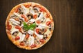 Pizza with chicken, tomato and mushrooms on dark wood background Royalty Free Stock Photo