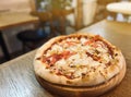 Pizza with chicken, tomatoes, corn and mozzarella is on the table in a plate. Restaurant food. selective focus Royalty Free Stock Photo