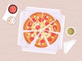 Pizza circle with cut triangle pieces in open takeaway box. Italian fast food with salami sausage and cheese, served Royalty Free Stock Photo