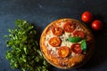 Pizza and condiments of tomatoes and mint leaves