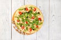 Pizza covered with roquette and shrimps on wooden table, top view. Royalty Free Stock Photo