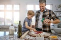 In pizza we crust. a father and his son making pizza at home. Royalty Free Stock Photo