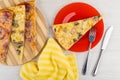 Pizza on cutting board, in plate, napkin, knife and fork Royalty Free Stock Photo