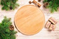 Pizza cutting board at table background with christmas decoration, Round board. New Year concept