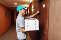 Pizza delivery boy knocking on door of customer Royalty Free Stock Photo