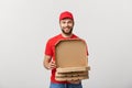 Pizza delivery concept. Young boy is delivering and showing pizza boxs in boxes. Isolated on white background Royalty Free Stock Photo