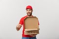 Pizza delivery concept. Young boy is delivering and showing pizza boxs in boxes. Isolated on white background Royalty Free Stock Photo