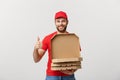 Pizza delivery concept. Young boy is delivering and showing pizza boxs in boxes. Isolated on white background Royalty Free Stock Photo