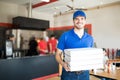 Pizza delivery man holding pizza boxes in restaurant Royalty Free Stock Photo