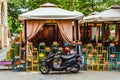 Pizza delivery man moped at a small cafe