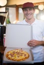 Pizza delivery man showing fresh pizza Royalty Free Stock Photo