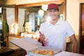 Pizza delivery man showing fresh pizza and thumbs up Royalty Free Stock Photo