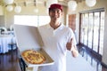 Pizza delivery man showing fresh pizza and thumbs up Royalty Free Stock Photo