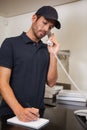 Pizza delivery man taking an order over the phone Royalty Free Stock Photo