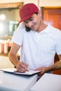 Pizza delivery man taking an order over the phone Royalty Free Stock Photo