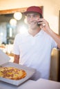 Pizza delivery man taking an order over the phone Royalty Free Stock Photo