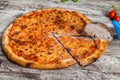 Pizza with different toppings. Italian pizza with different sorts of cheese, vegetables and meat on old wooden background close up Royalty Free Stock Photo