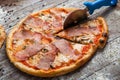 Pizza with different toppings. Italian pizza with different sorts of cheese, vegetables and meat on old wooden background close up Royalty Free Stock Photo