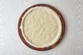 Pizza dough, 2nd step of spread the pizza dough on wooden board on gray background. How to make Pizza?