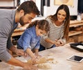 Pizza, dough and parents with child in kitchen and tablet for recipe, guide and learning together. Family, cooking and Royalty Free Stock Photo