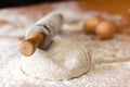 Pizza dough on the table with more products to make the pizza