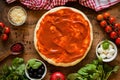 Pizza dough with tomato sauce and igredients for pizza. Top view Royalty Free Stock Photo