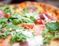 Pizza with dry cured ham and arugula Royalty Free Stock Photo