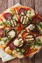 Pizza with eggplant, salami, corn and mozzarella close up. Verti Royalty Free Stock Photo