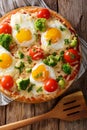 Pizza with eggs, cheese, broccoli, tomatoes and herbs close-up. Royalty Free Stock Photo