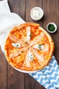 Pizza with fish and cream cheese - Plaisir on a wooden background. Royalty Free Stock Photo