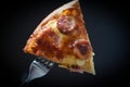 Pizza on fork / Slice pizza piece on the dark black Royalty Free Stock Photo