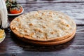 Pizza four cheeses on a wooden board in a restaurant Royalty Free Stock Photo