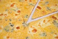 Pizza with four different cheeses in a white plate, one piece cut off, macro