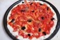 Pizza with fresh chopped tomato and black olives