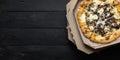 Pizza funghi in an open delivery box, dark backdrop with text space.