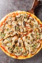 Pizza funghi with tomato sauce, mozzarella and fresh mushrooms close-up on a wooden board. Vertical top view