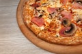 Pizza with ham, mushrooms and cheese on a board Royalty Free Stock Photo