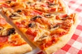 Pizza with ham and mushrooms. Delicious hot food sliced and served on white platter. Menu photo, Italian fast food.