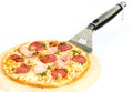 Pizza with ham, mushrooms, salami and pesto sauce Royalty Free Stock Photo