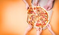 Pizza hands. Several hands take pizza at the same time, view above. Hot tasty take out pizza from the box for group of people.