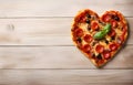 pizza heart shape on light wooden background top view